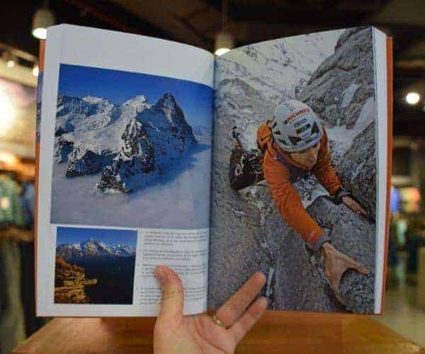 Descripción: Un libro abierto con una imagen de un montañista.