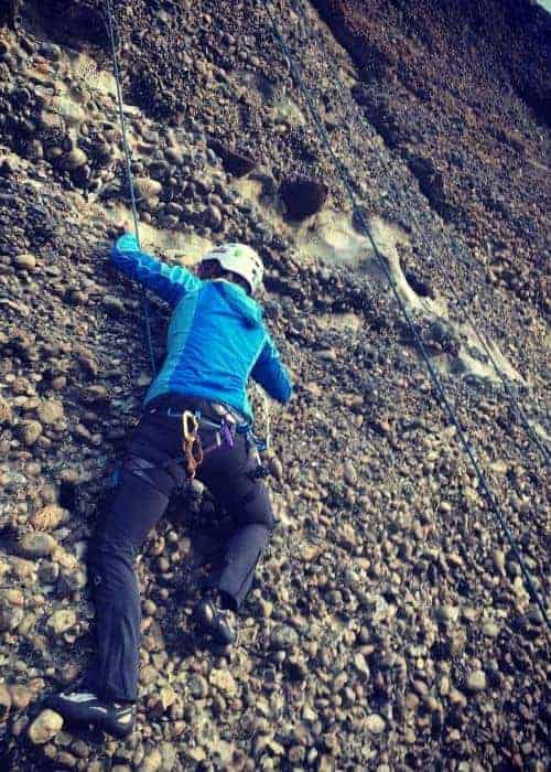 Una persona escalando una pared rocosa patagónica.
