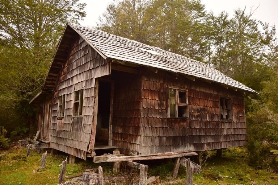 Una antigua cabaña de madera se encuentra en medio de los Andes.